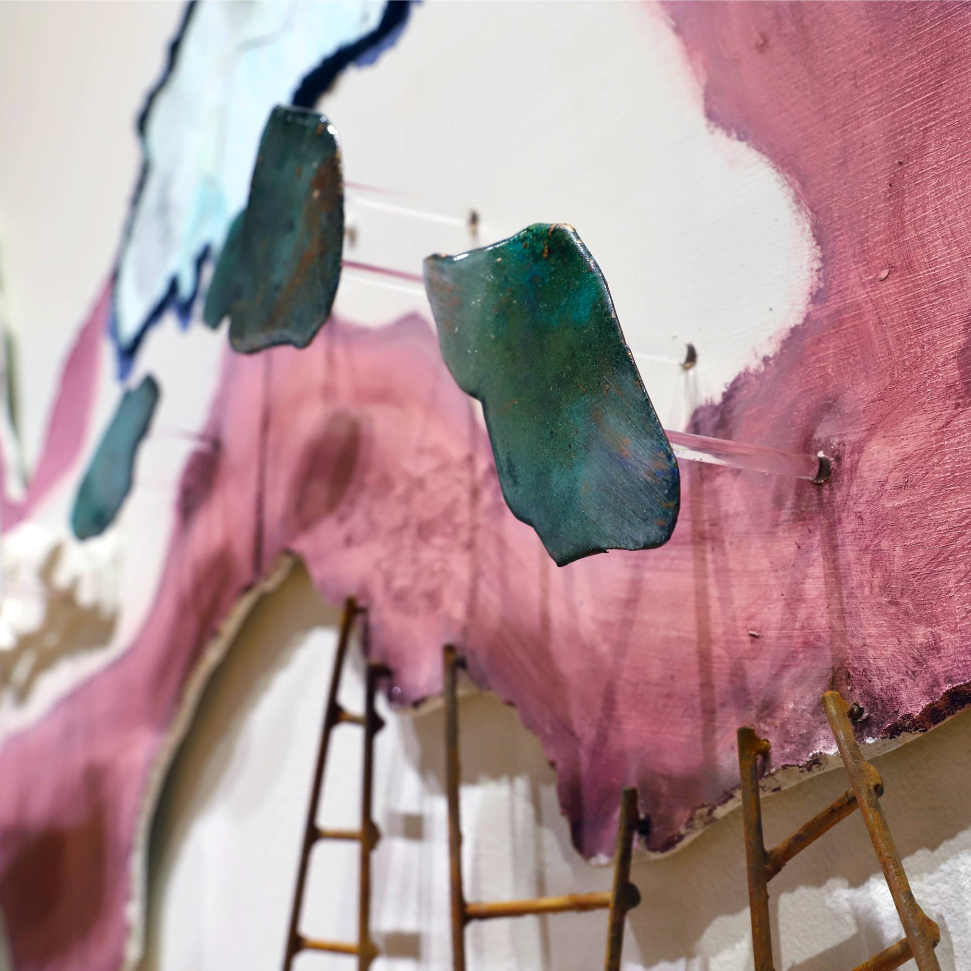 black and white photograph of three cats sitting in front of doorway in cobblestone alley